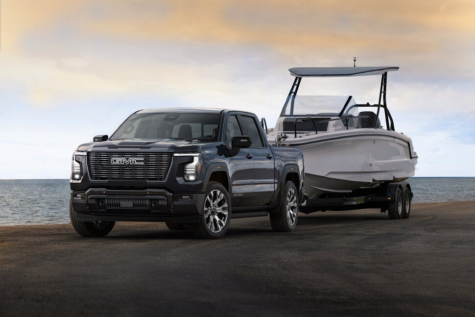 2027 GMC Sierra 1500 Denali Ultimate towing a boat