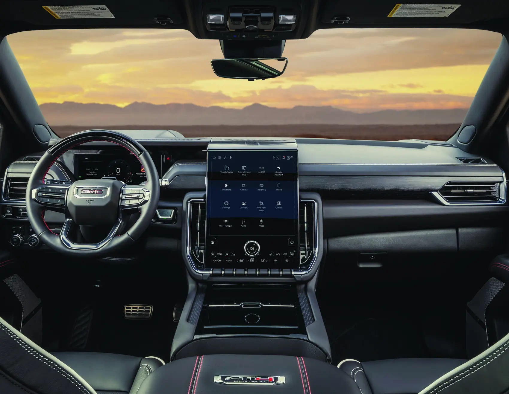 2027 GMC Yukon AT4 Ultimate Obsidian Rush interior with red accents at dusk
