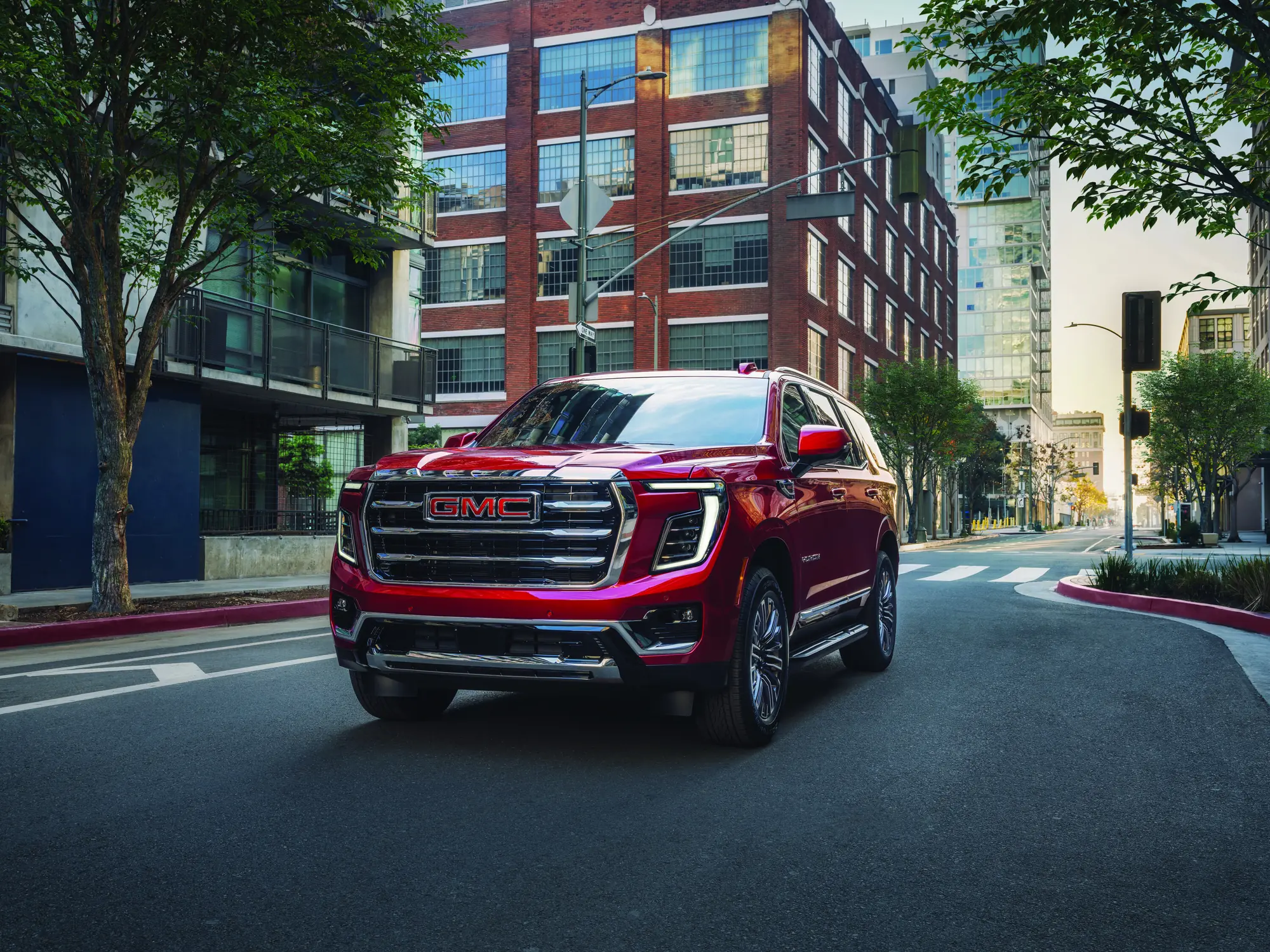 2027 GMC Yukon Elevation in Volcanic Red Tintcoat, front grille, headlamps and fog lamps