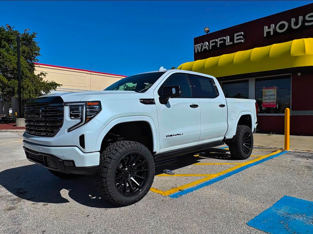 Lifted white GMC Sierra 1500 Denali parked in Tampa Florida