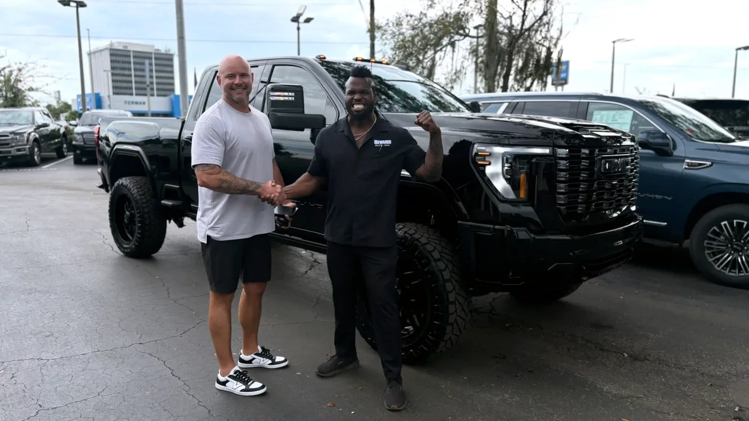 Justin taking delivery of his blacked out Sierra Denali Ultimate HD build