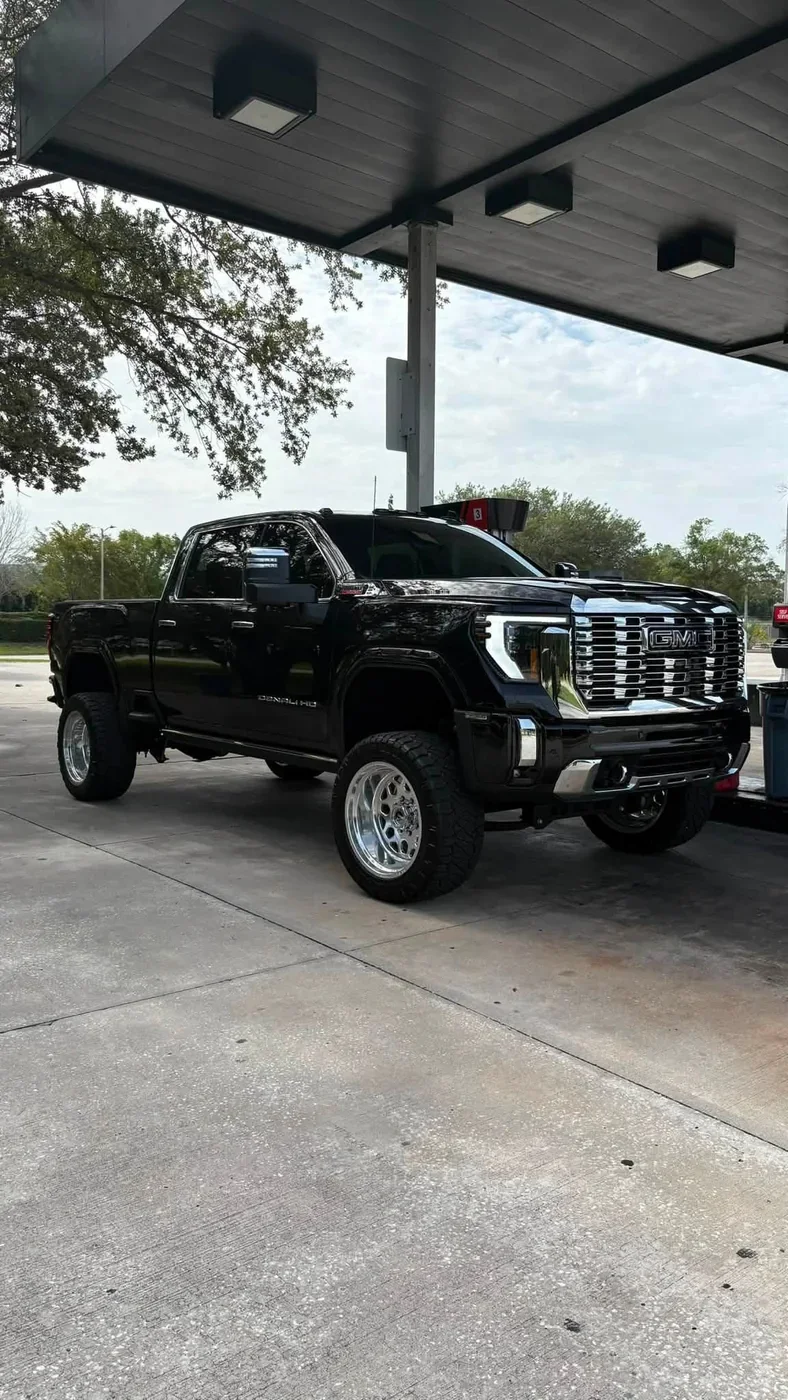 Lifted black GMC Sierra Denali HD on polished forged wheels