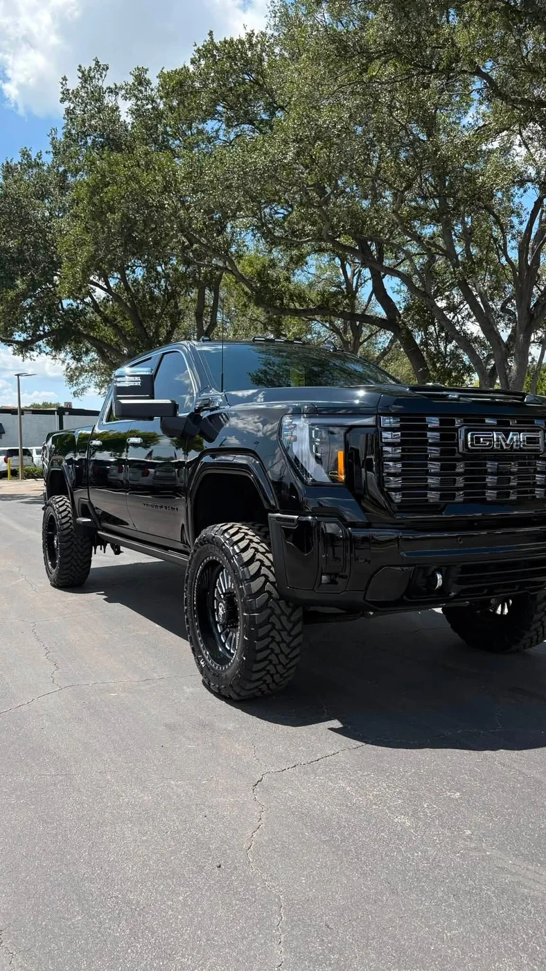 Blacked out lifted GMC Sierra Denali HD on black wheels