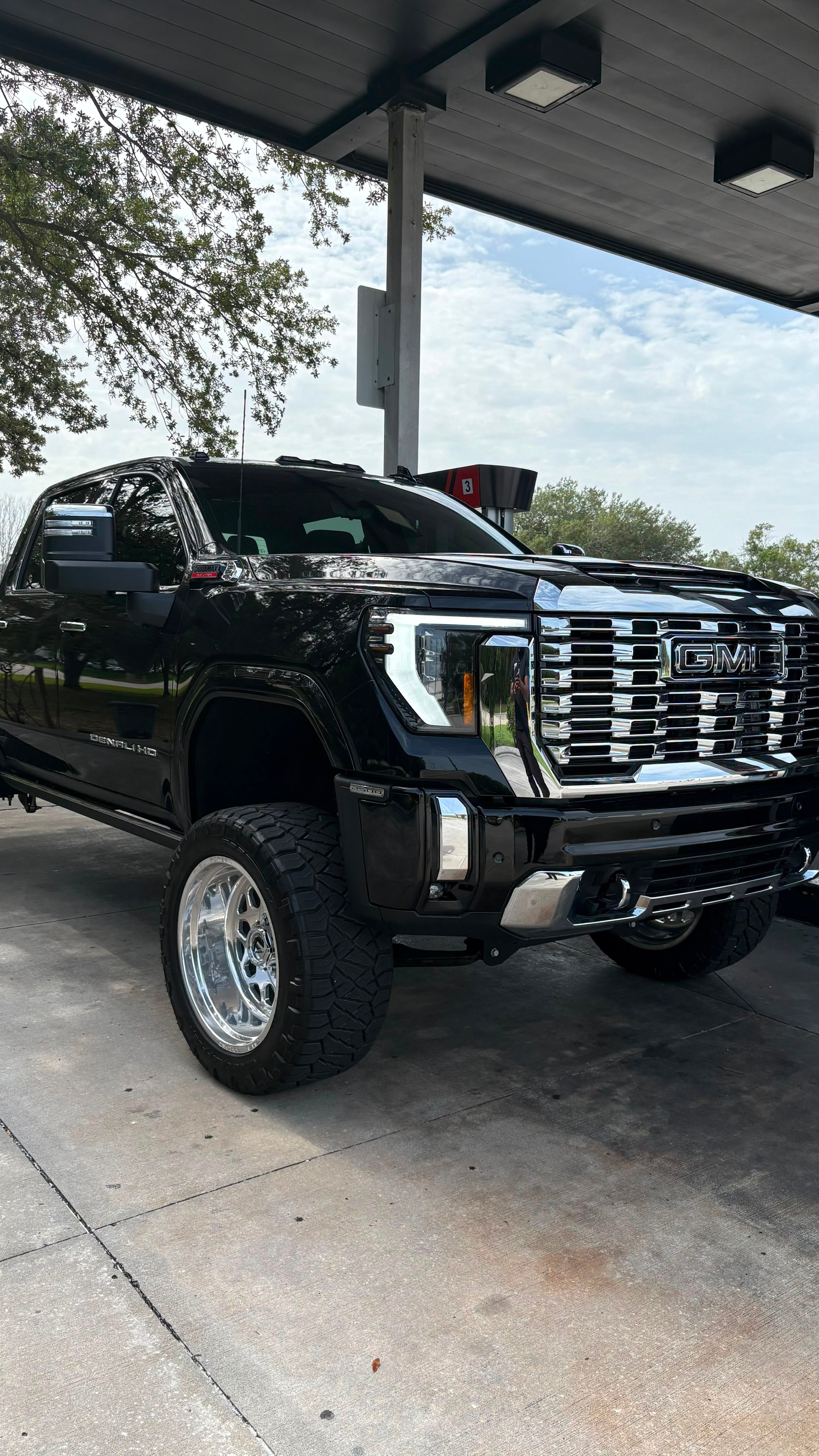 Lifted black GMC Sierra Denali HD on polished forged wheels