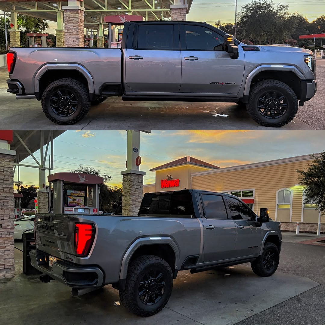 Side and rear views of a lifted silver GMC Sierra 2500 HD AT4