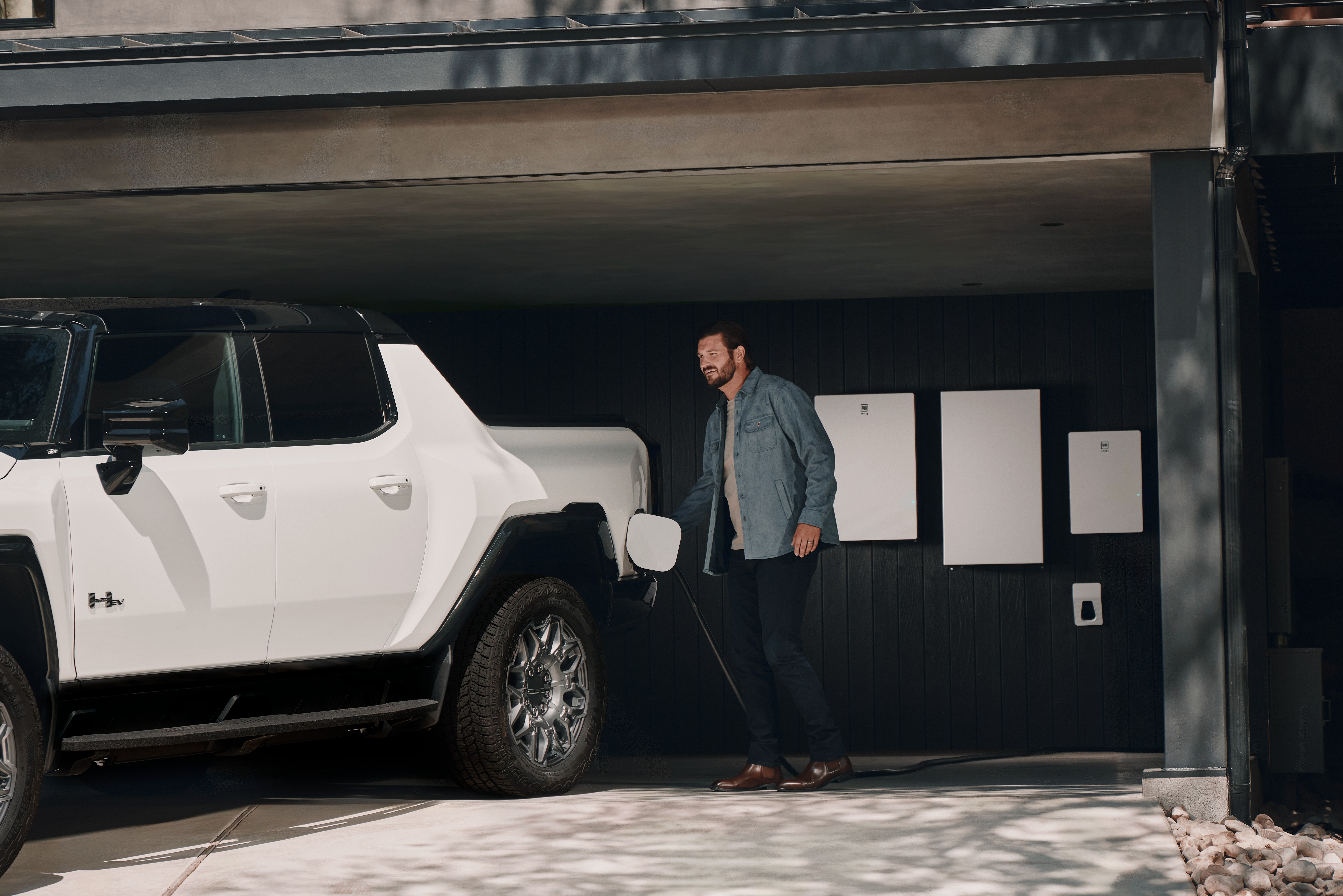 GMC Hummer EV Pickup charging at home with GM Energy PowerBank wall units