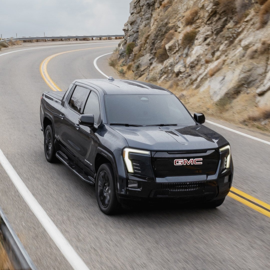 2026 GMC Sierra EV Denali driving a mountain highway