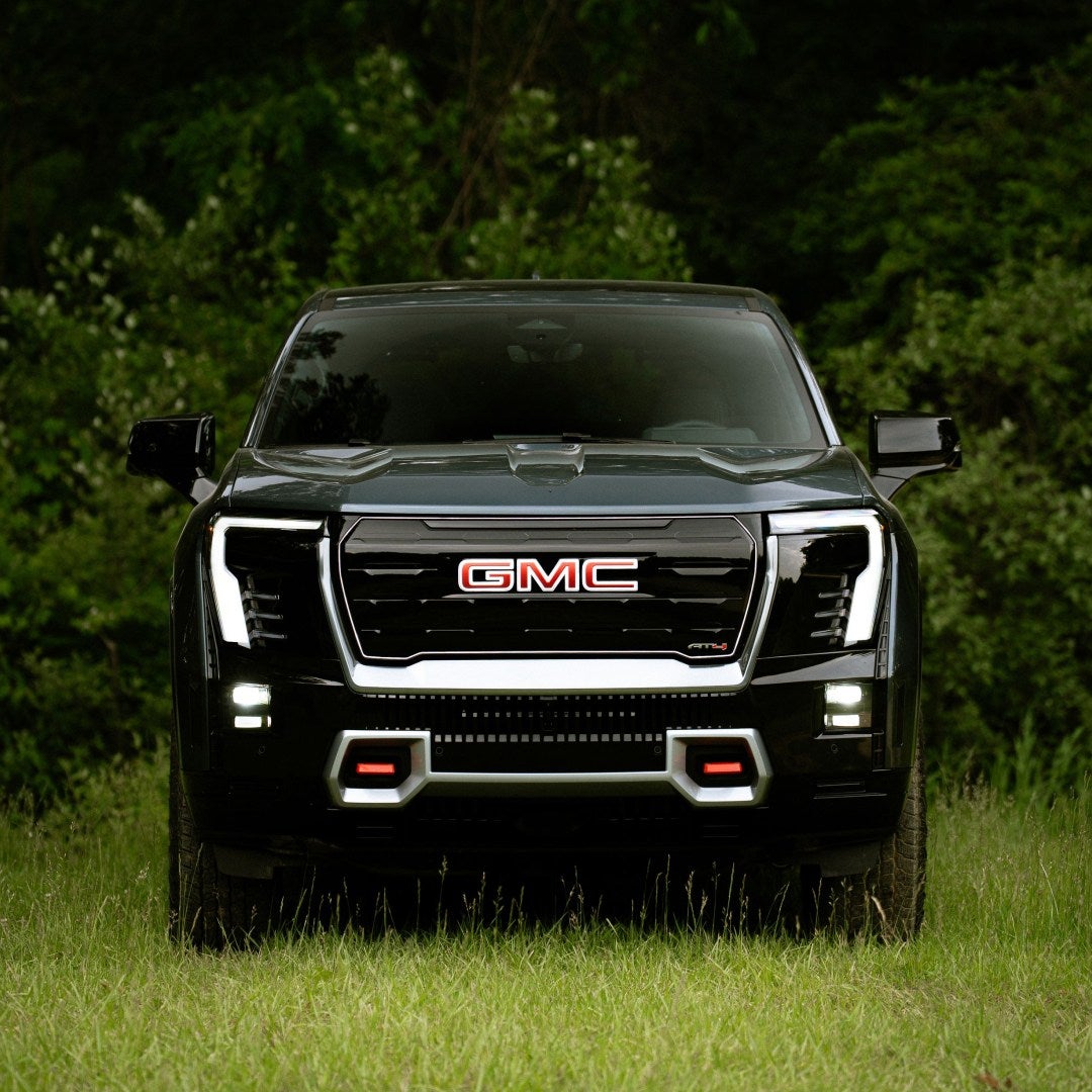 2026 GMC Sierra EV front view parked in tall grass