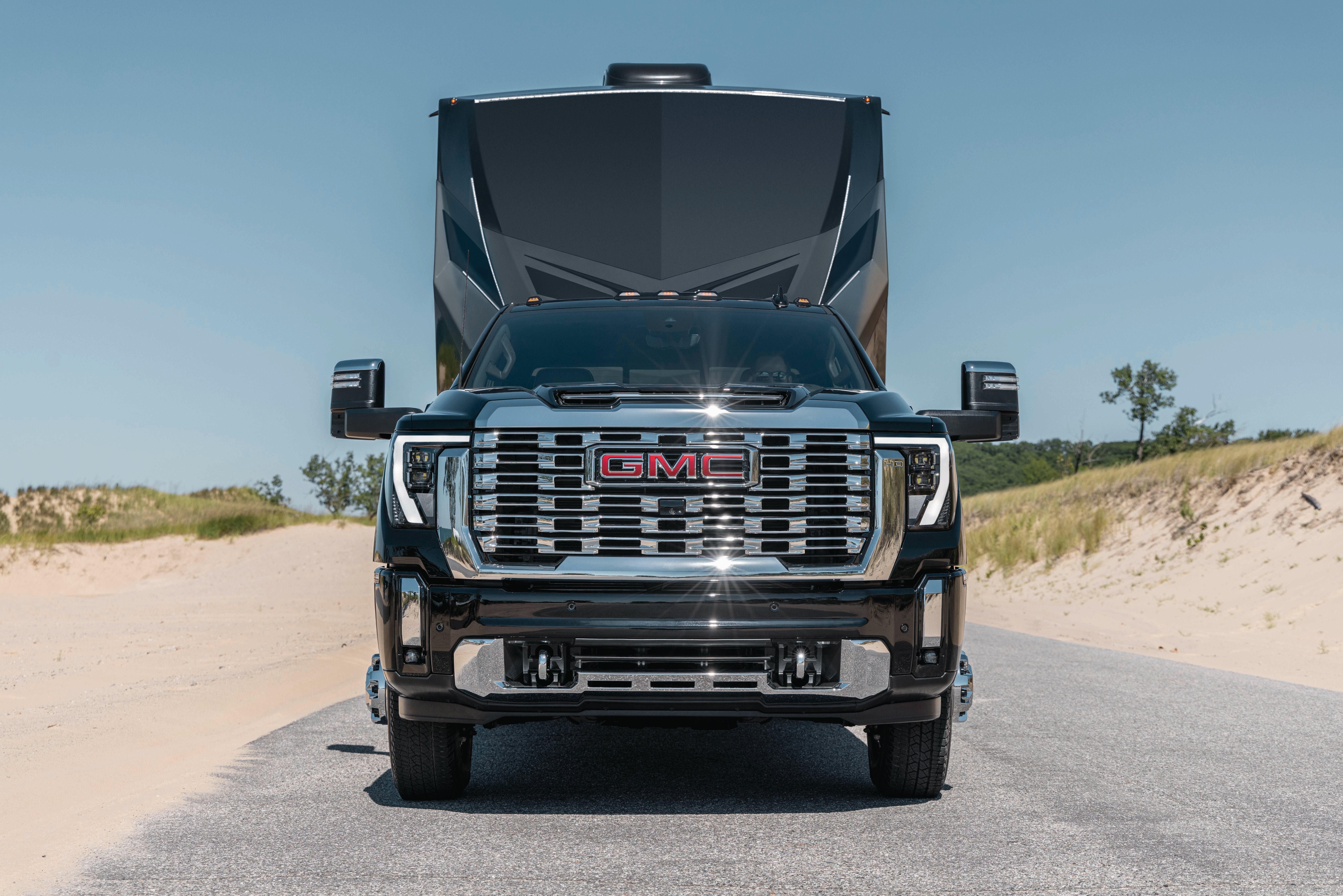2027 GMC Sierra 3500HD Denali dually towing a large fifth-wheel trailer